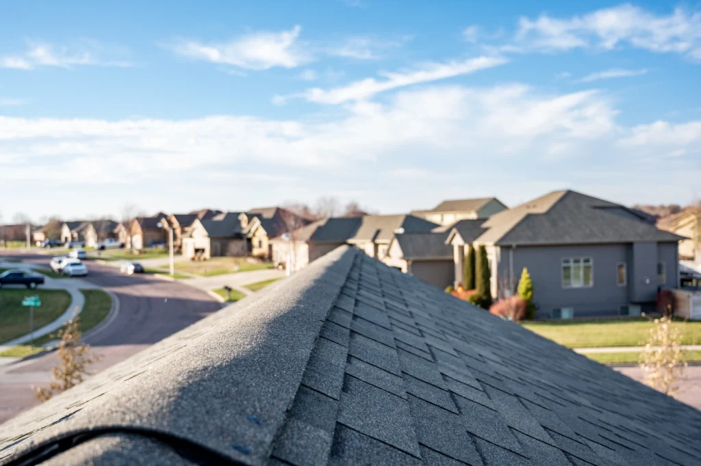 roof ridge view of new roof installation using asphalt shingles