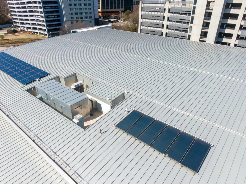 Commercial roofing installation completed by I AM Roofing featuring a standing seam metal roofing system on a large commercial building