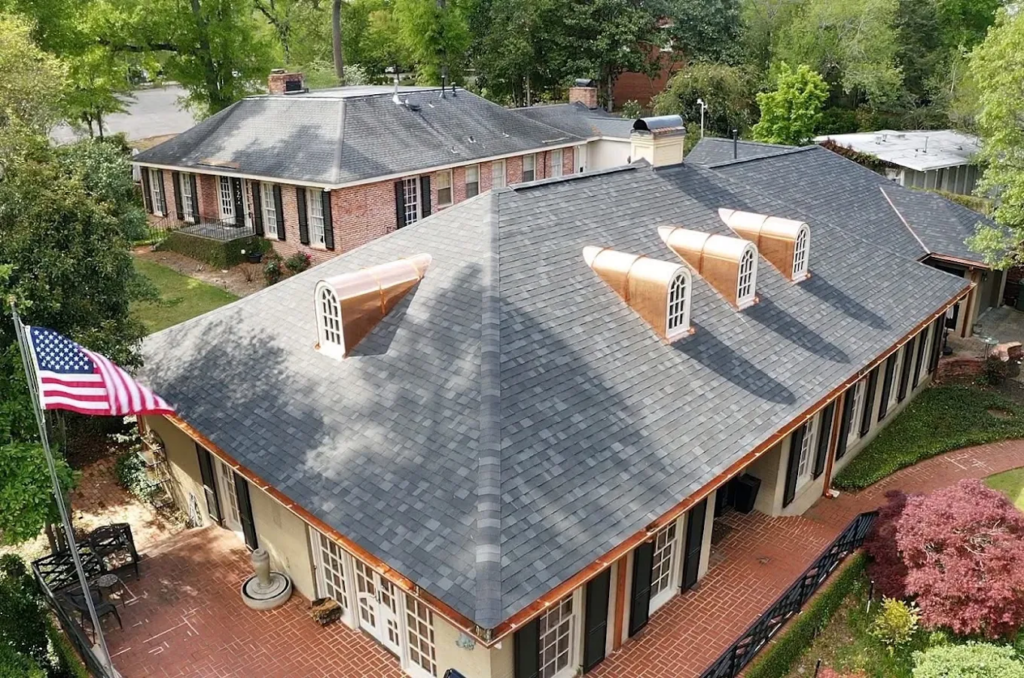 Aerial view of a shingle roof with dormers on a home in Millbrook, AL